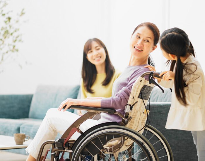 Mother in a wheelchair looking back at her daughter
