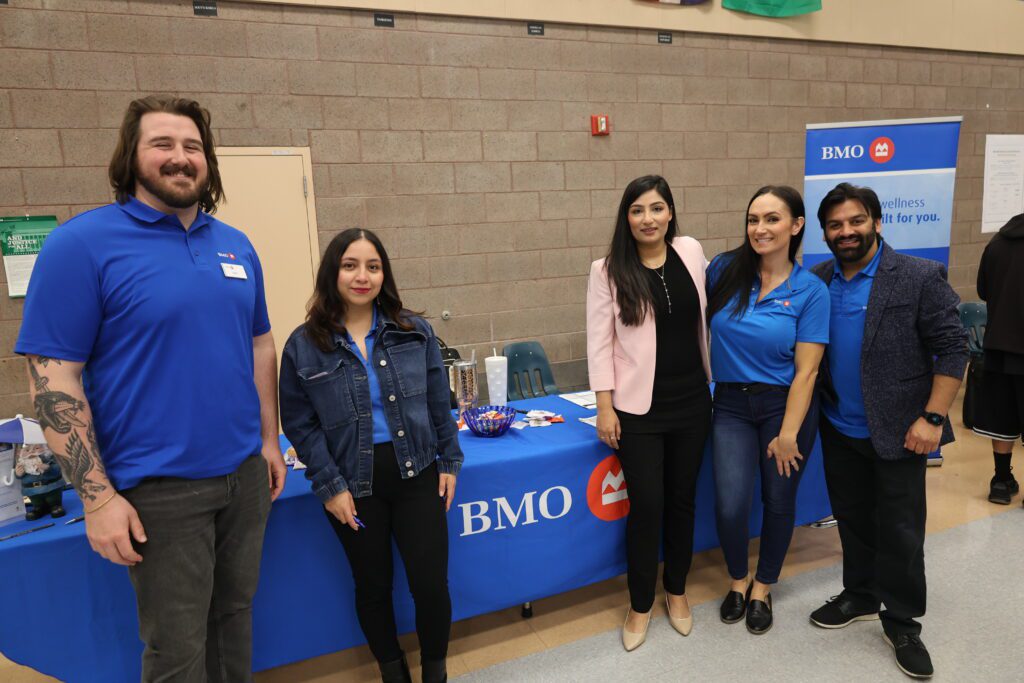 Group photo of 5 BMO staff in front of their resource table