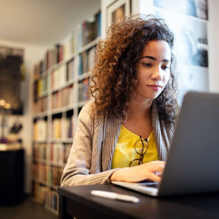 Young woman typing on a laptop